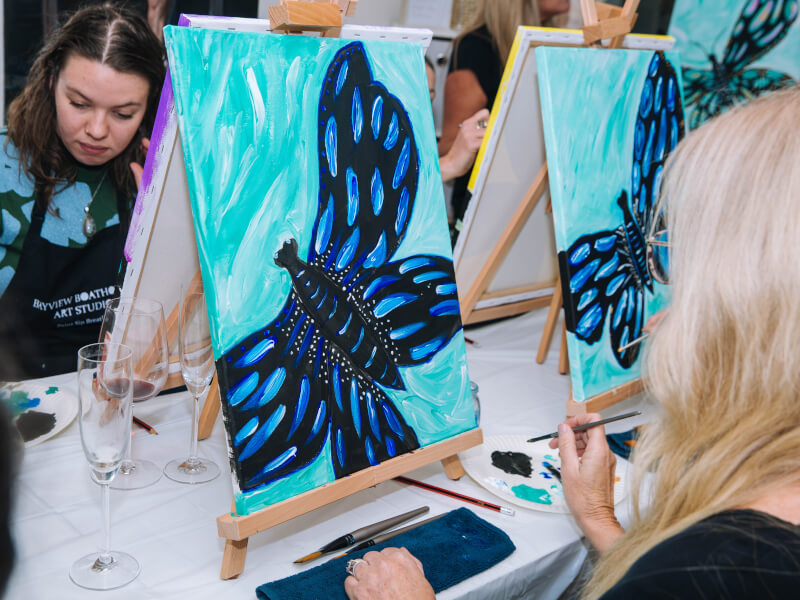 Woman painting a butterfly